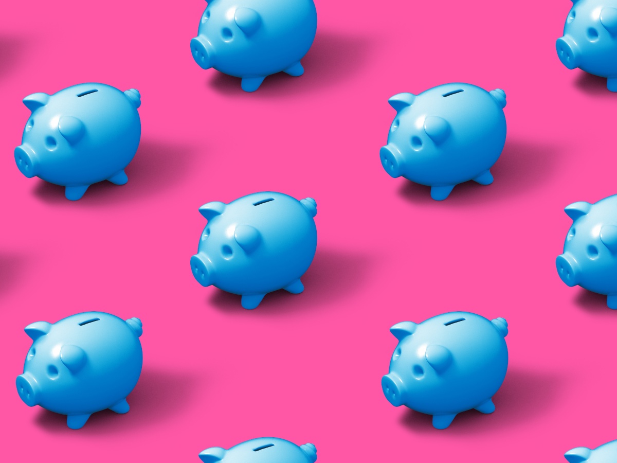 Bright blue piggy banks against a neon pink background.