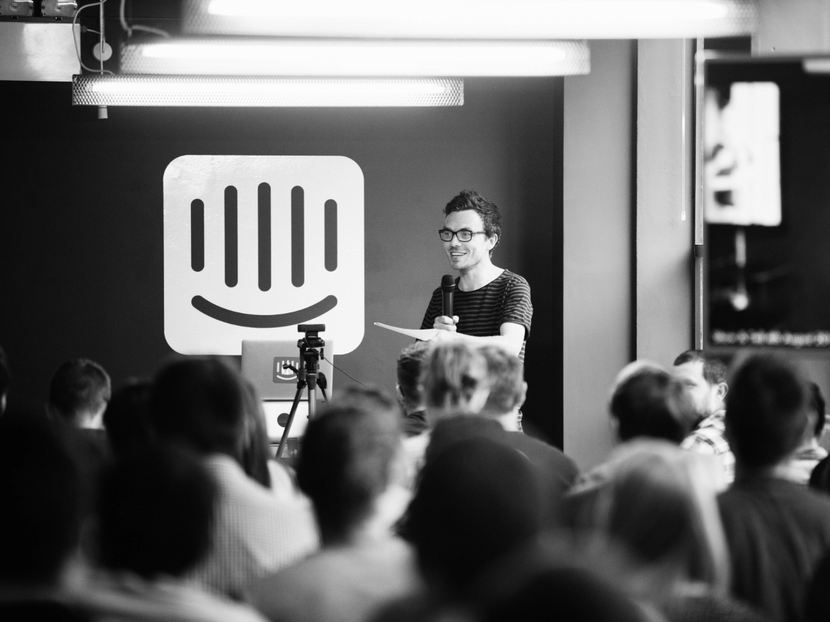 Intercom office space with a large logo in the back of the room. Picture taken in black and white.