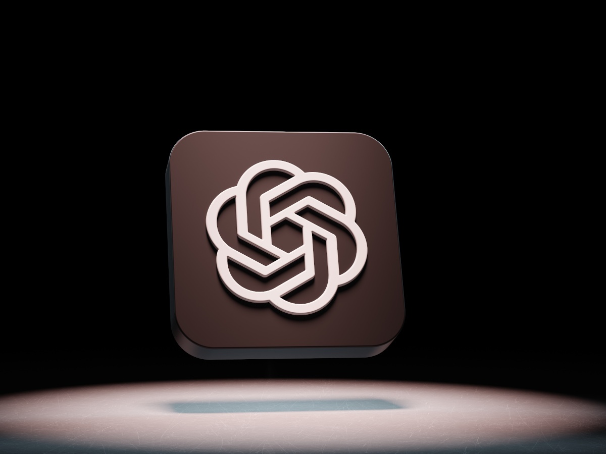 A black tile floating in a spotlight with the OpenAI white logo on it.