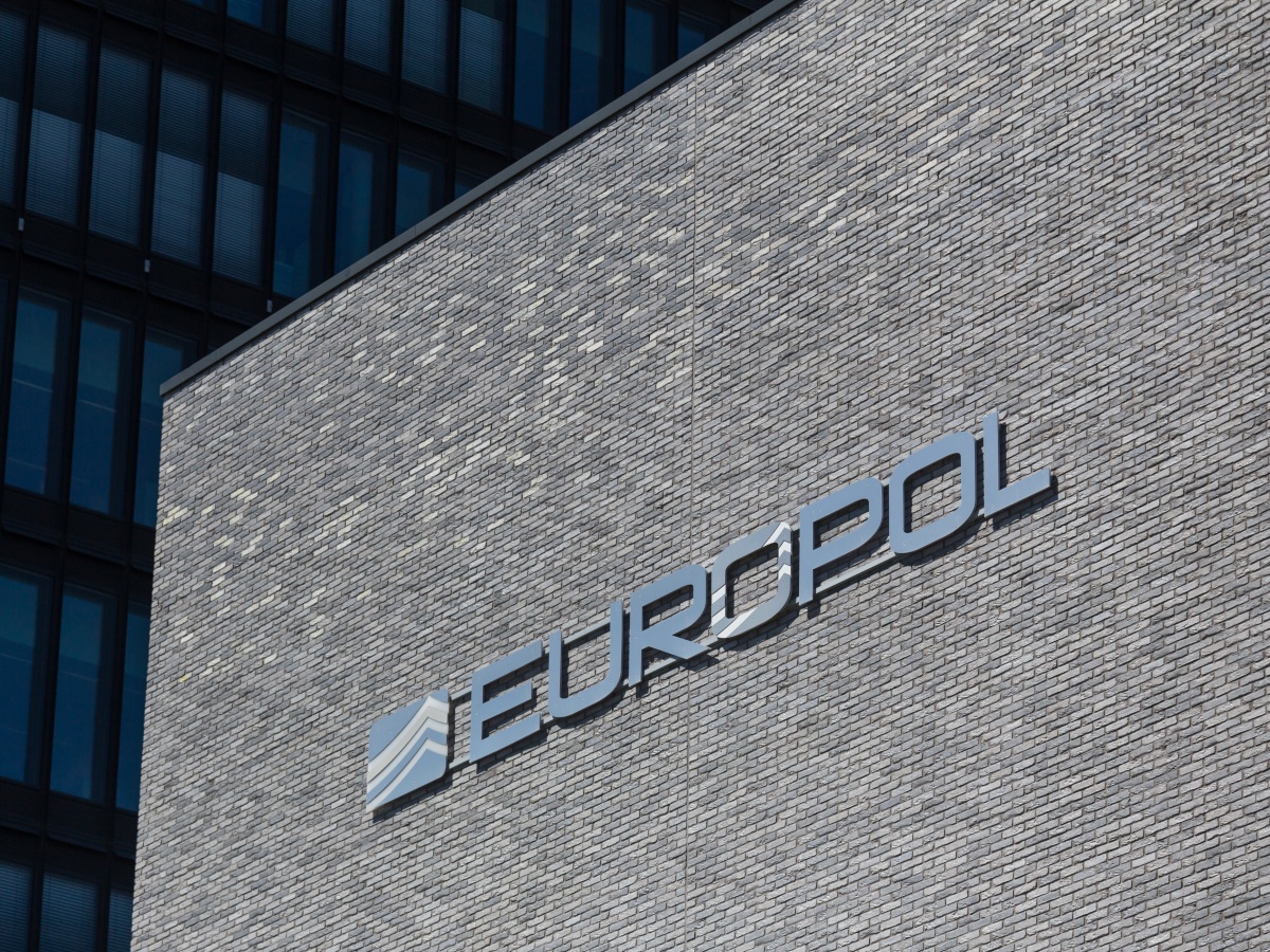 Europol logo on a large wall with grey bricks.