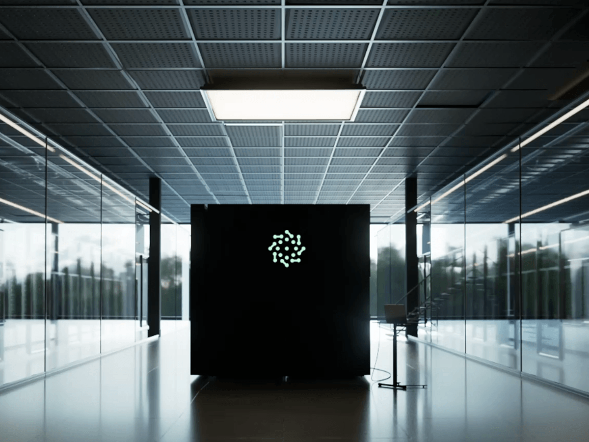A black QPU, branded for Pasqal, sits in a long hallway.