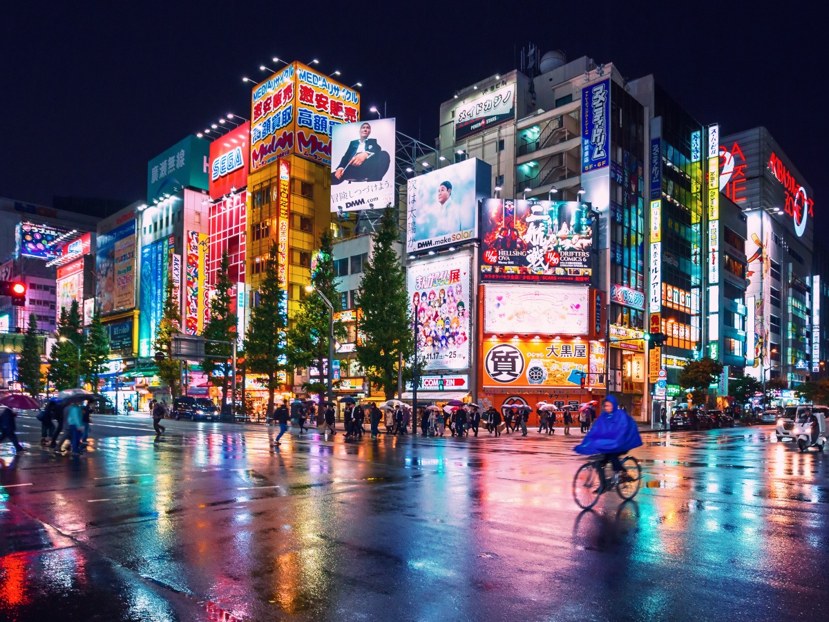 Neon lights and billboard advertisements on buildings at Akihabara, Tokyo at rainy night.