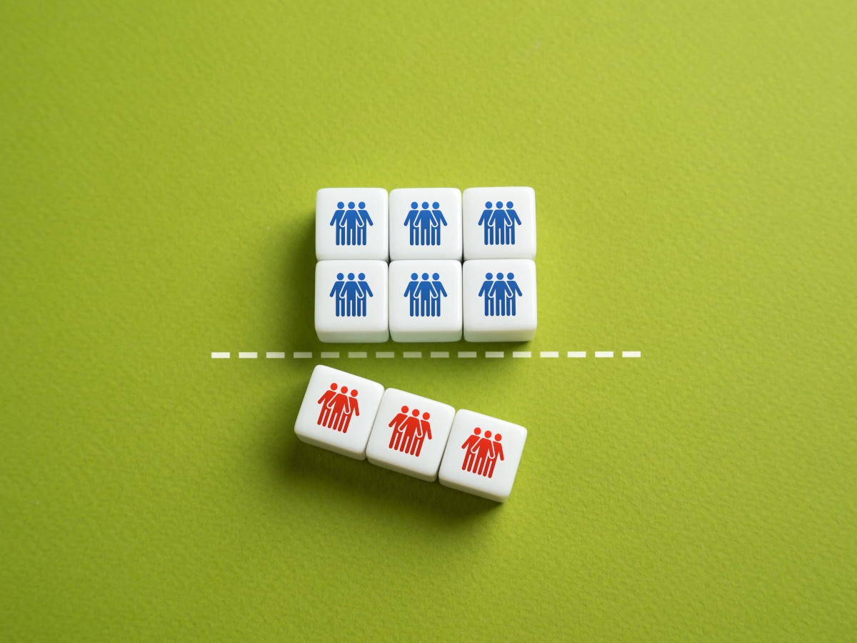 Green background and nine small white tiles. Six on top have blue figures on them, the three in the bottom have red, signifying job cuts.