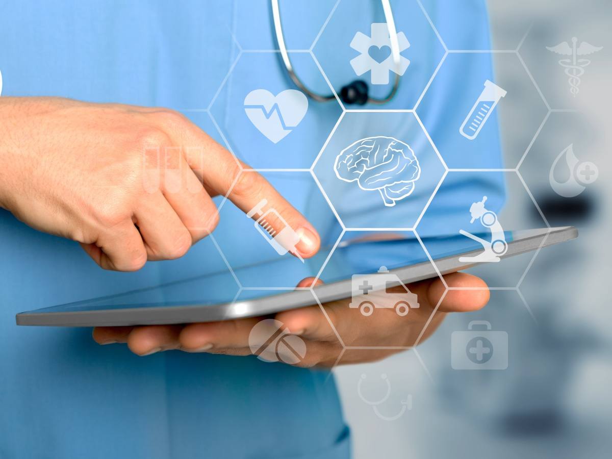 A healthcare professional uses an iPad that has AI icons coming out of it.
