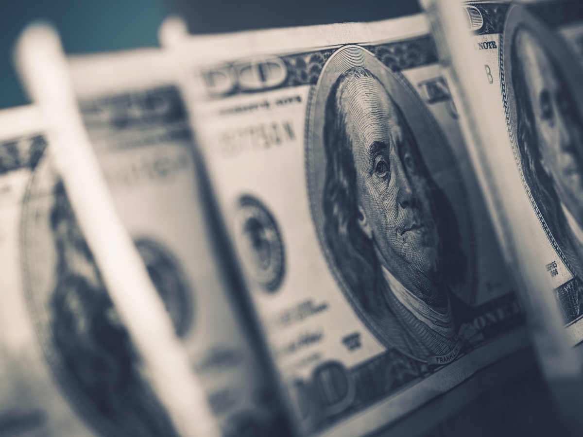 A close-up of a stack of US dollars.