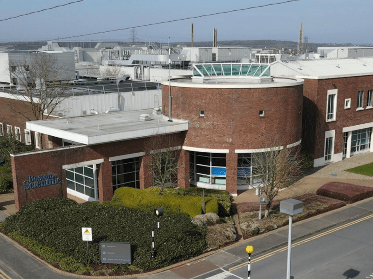 A brown medical facility against a blue sky.