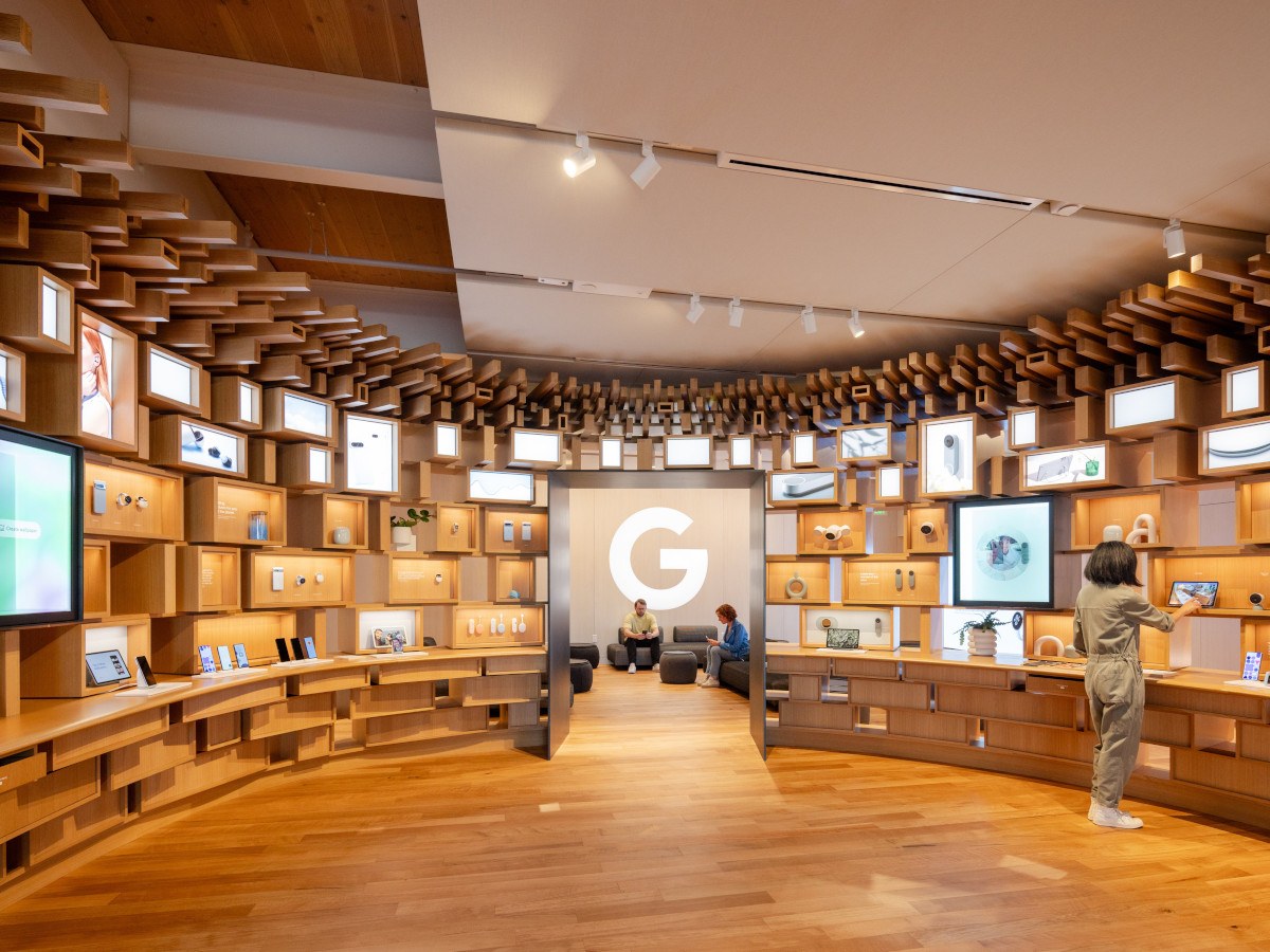 A curved room with wooden panels and shelving. Google
