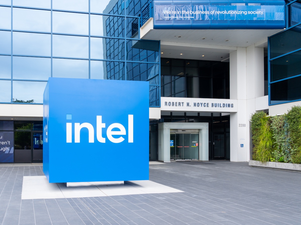 The Intel logo on a large blue cube placed outside an Intel building.