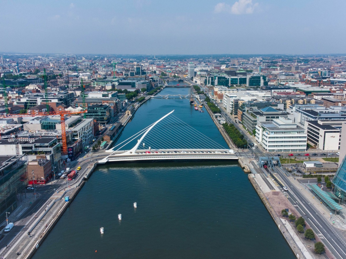 An aerial shot of the Samuel Beckett bridge over the River Liffey in Dublin on a bright, clear day.