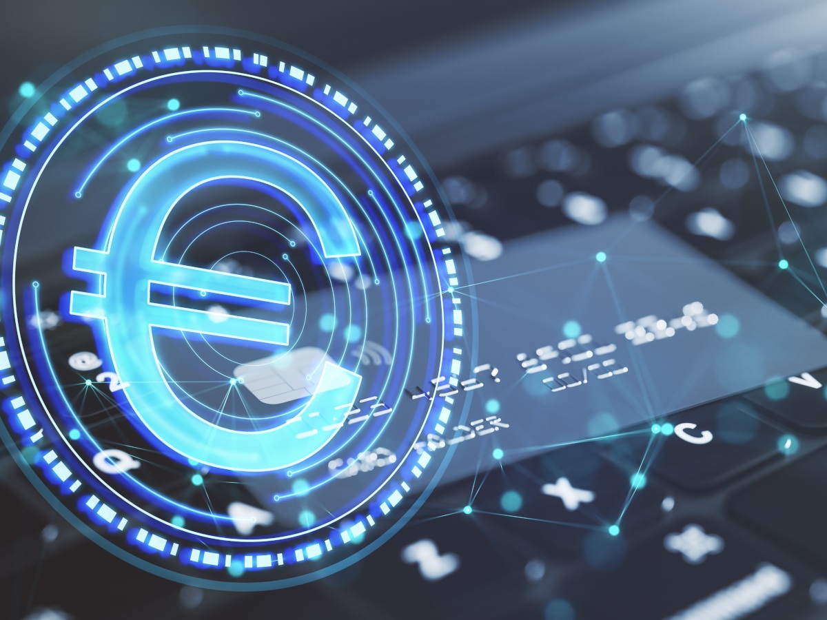 Close up of laptop keyboard and bank card with abstract blue digital euro coin with polygonal bokeh mesh on blurry background.