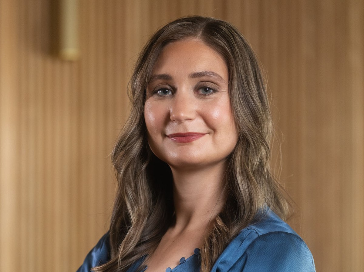 woman in blue shirt smiles to camera