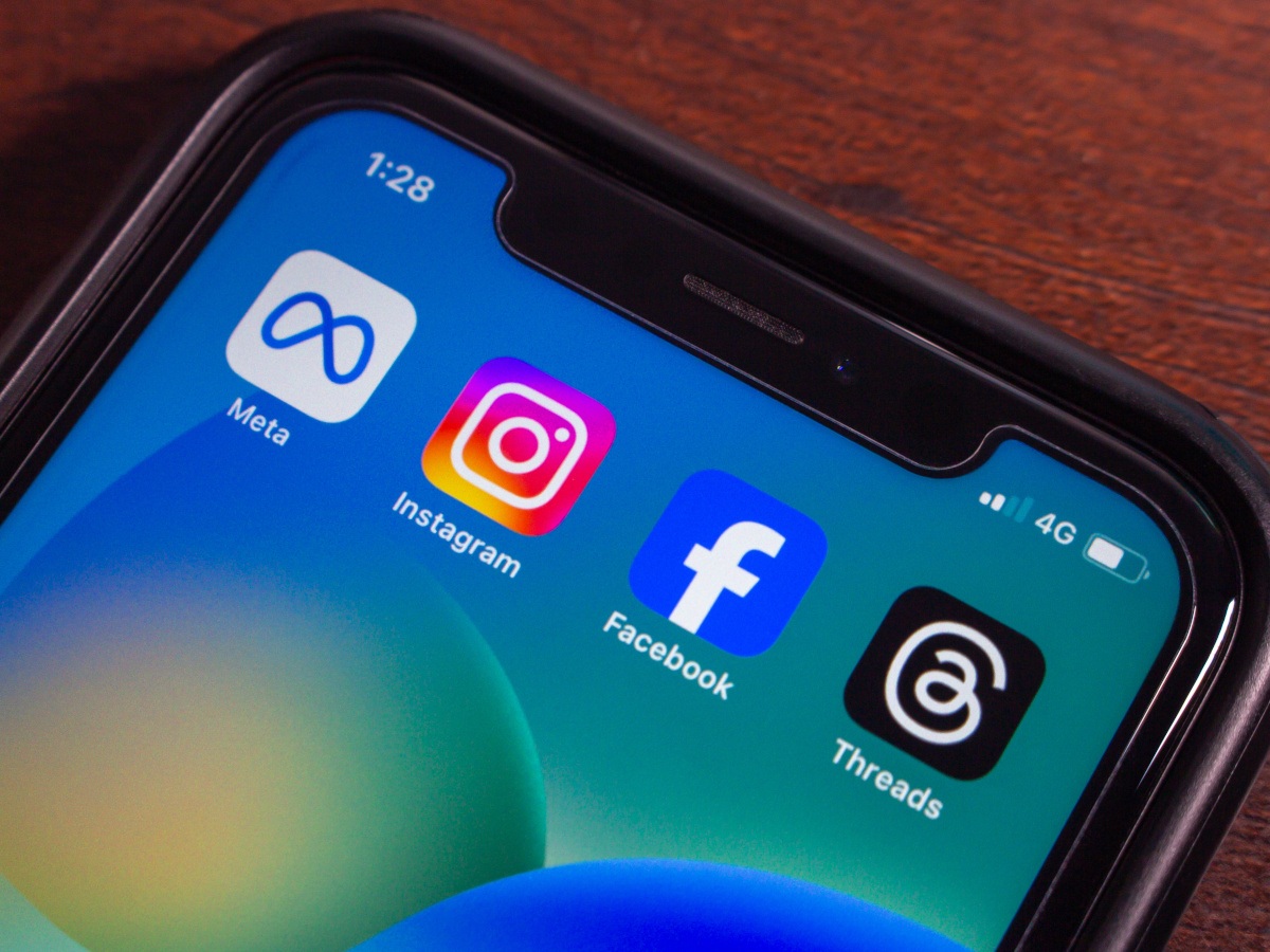 Four meta based app icons on an open mobile phone.