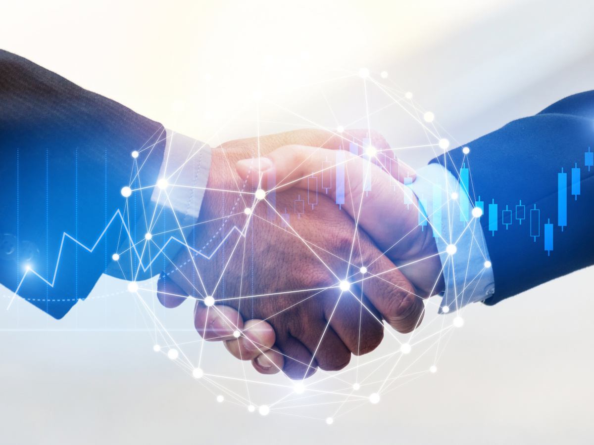 Two business men in suits shake hands, a move which creates a 3-D wave of connection.