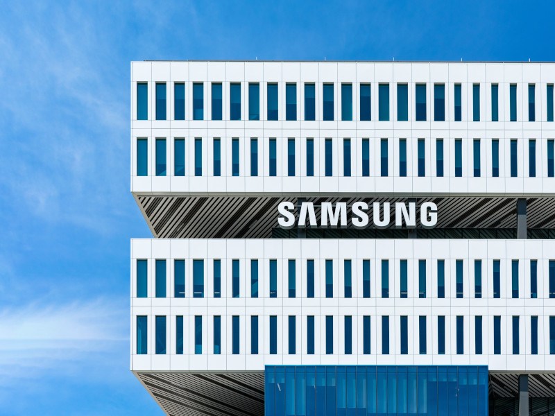 Samsung logo on a building with the blue sky visible behind.
