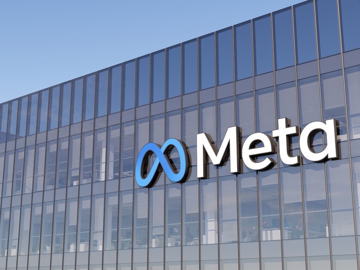 The Meta logo against a glass building