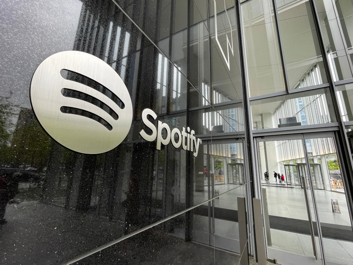 Spotify logo on a building with a shiny dark grey wall.