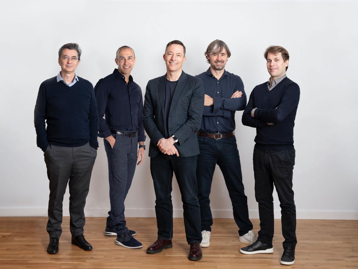 Five caucasian men stand