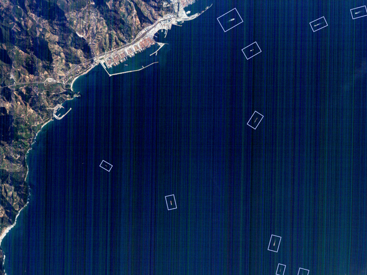 A satellite image of a port with ships outlined with rectangular boxes.