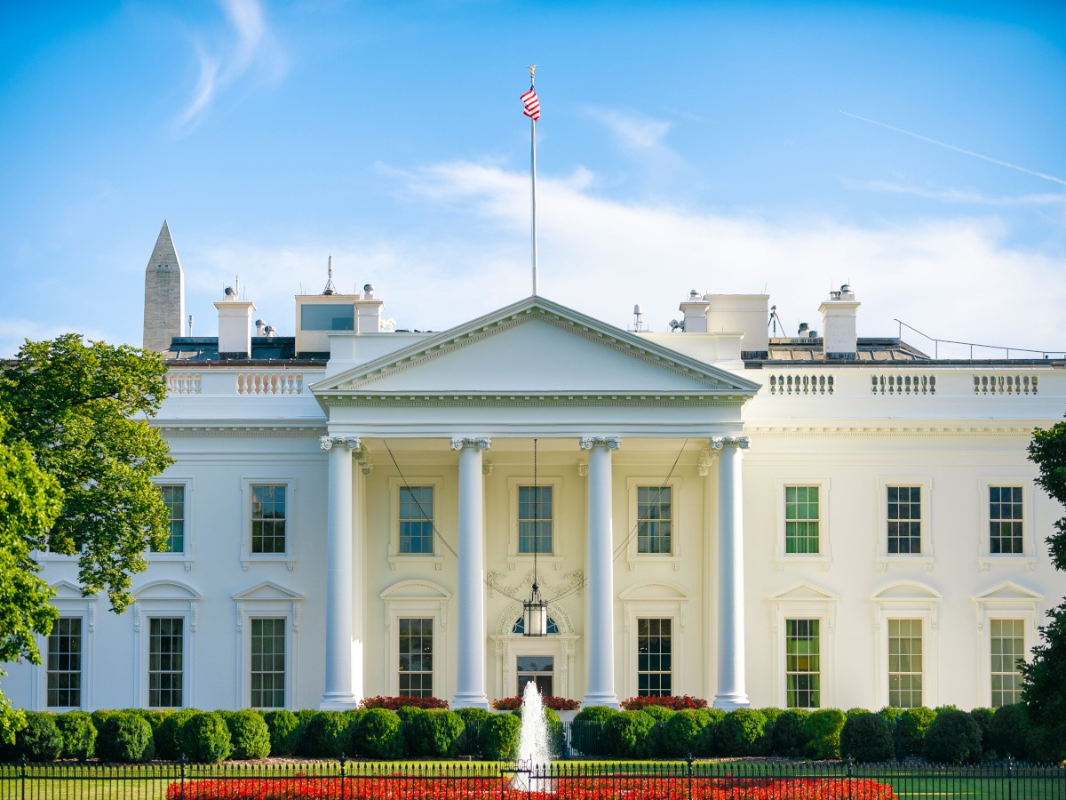 The White House on a summer day with blue skies.