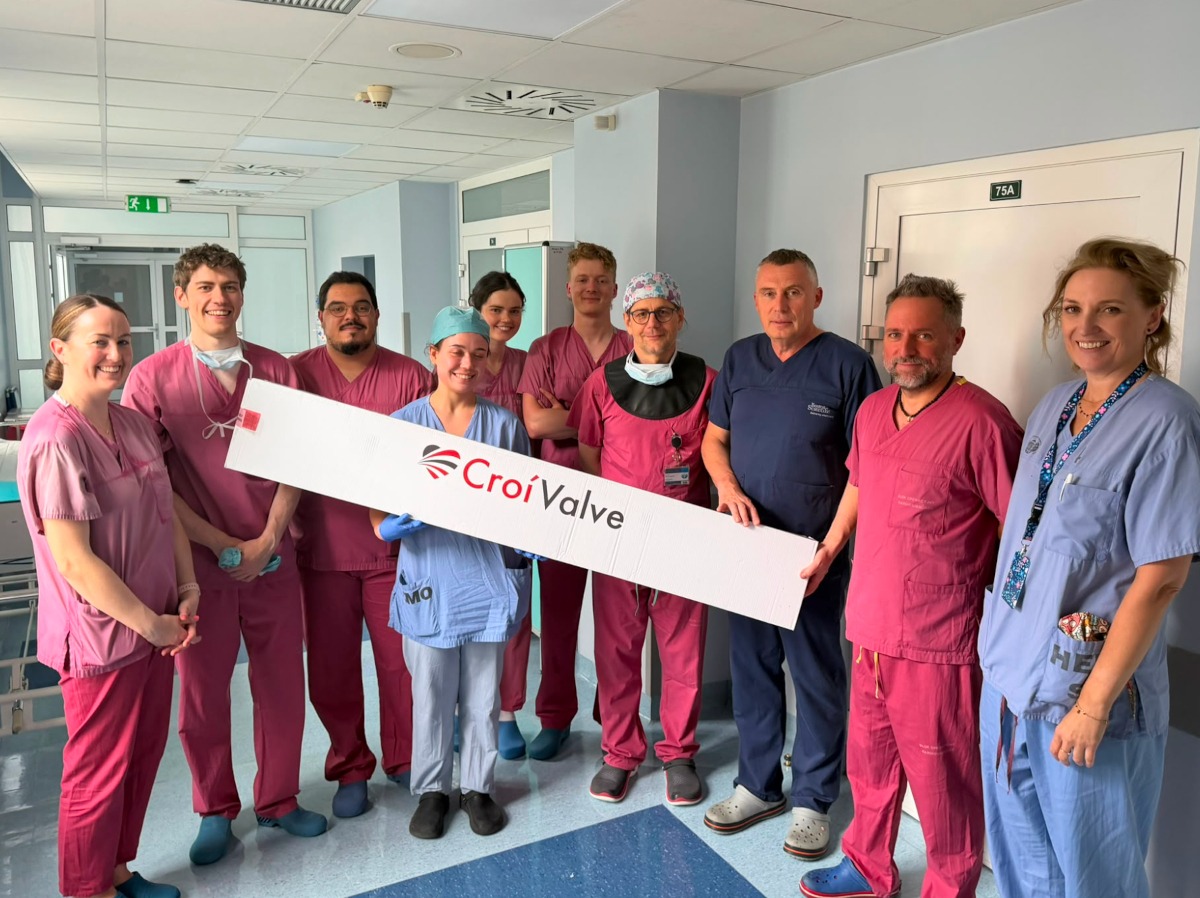 A group of people in scrubs holding a sign.