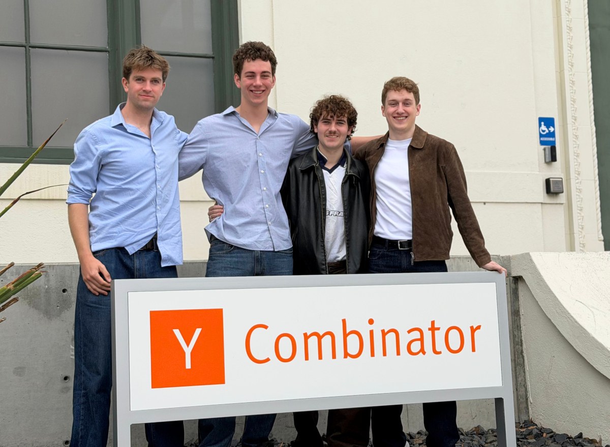 four young men behind Y Combinator sign