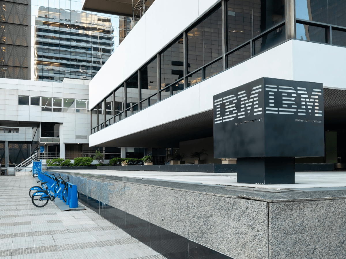 The stone and glass IBM building with blue bikes outside.