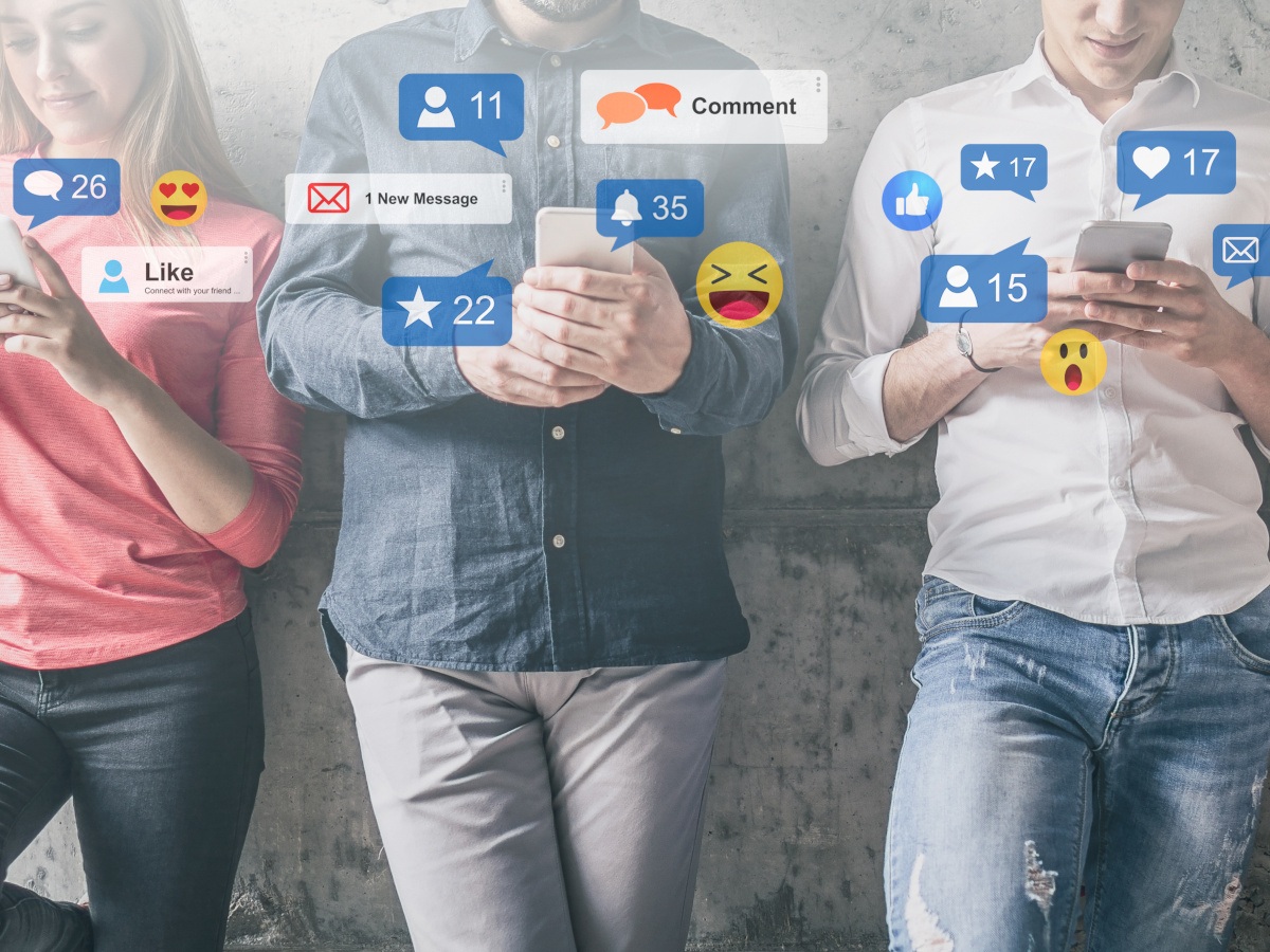 Young people with the shadow of social media icons overlapping.