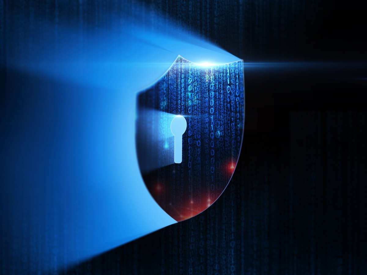A digital illustration of a shield with a keyhole in the middle illuminated by a blue light from behind as it shines around the shield.