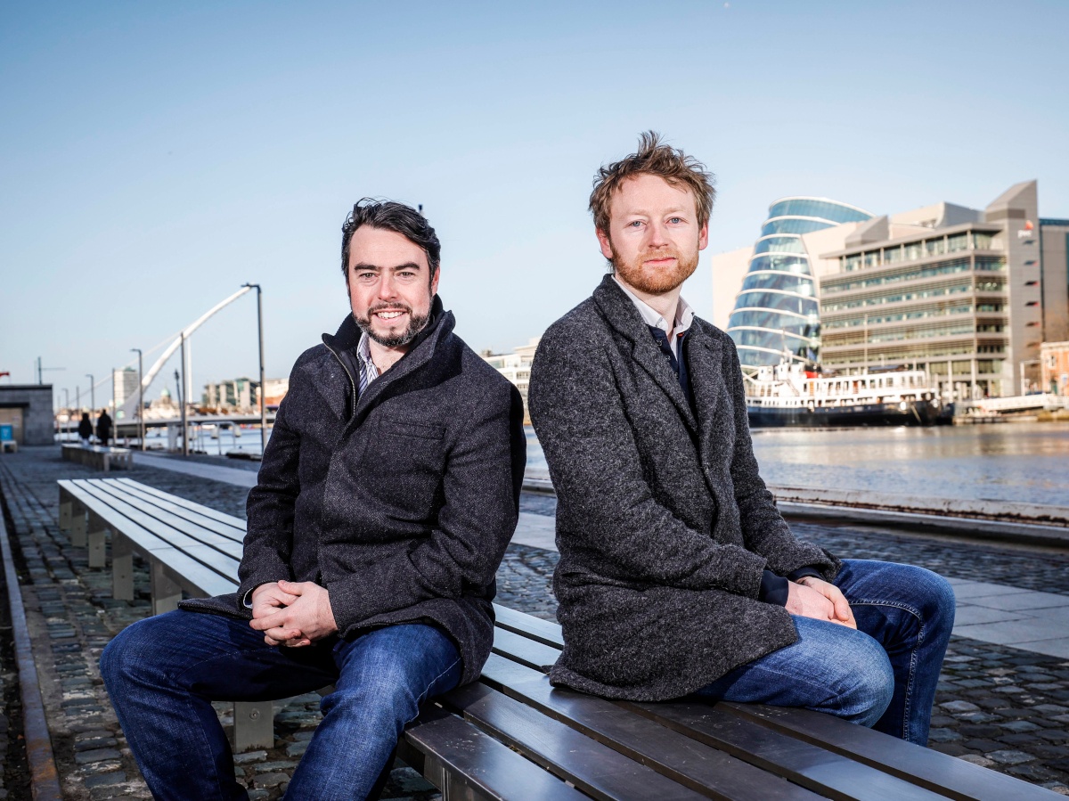 two caucasian men in urban riverside location