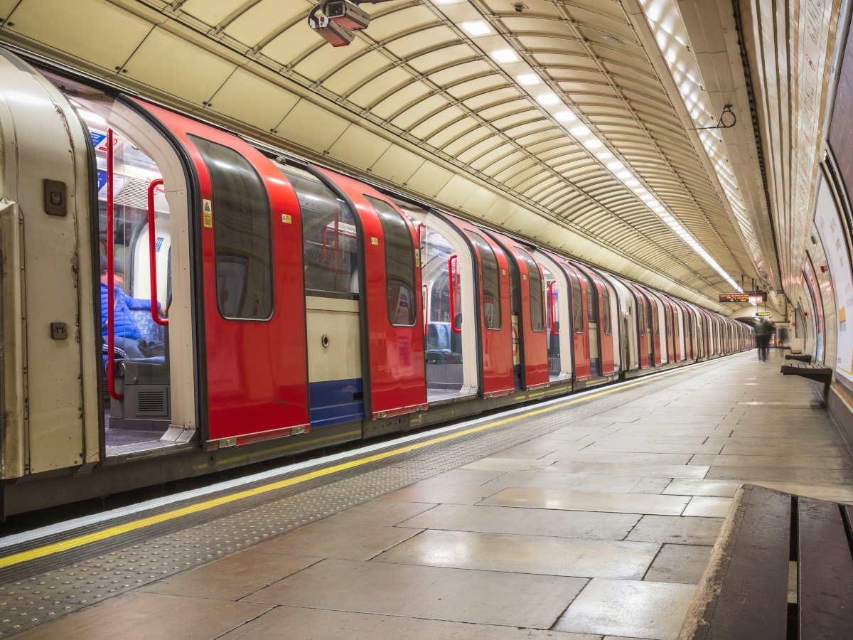 A picture of a train stopped at a platform on the London Underground.