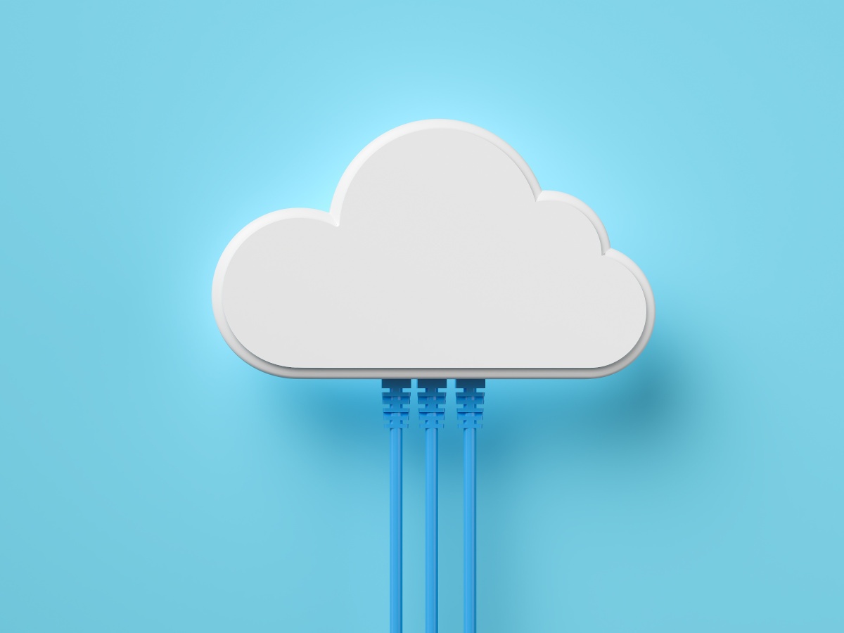 A white cloud on a blue background with three blue power cords coming out of the bottom to symbolise cloud computing.