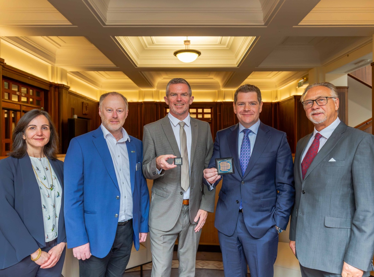 five people look to camera holding chips