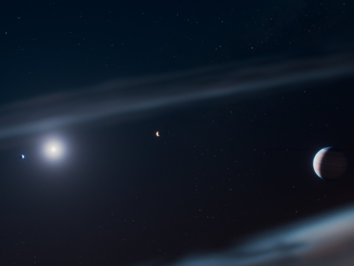 A mostly dark space with faint signs of a star and some planets around it.