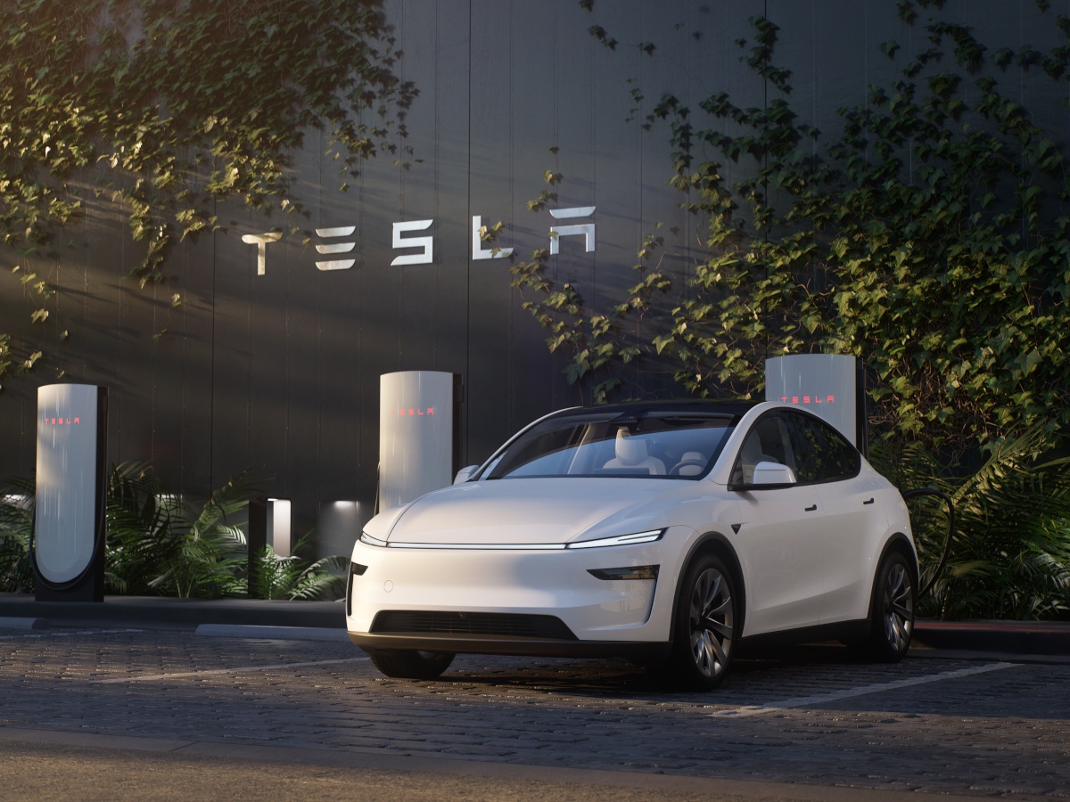 White Tesla Y Model at charging station.