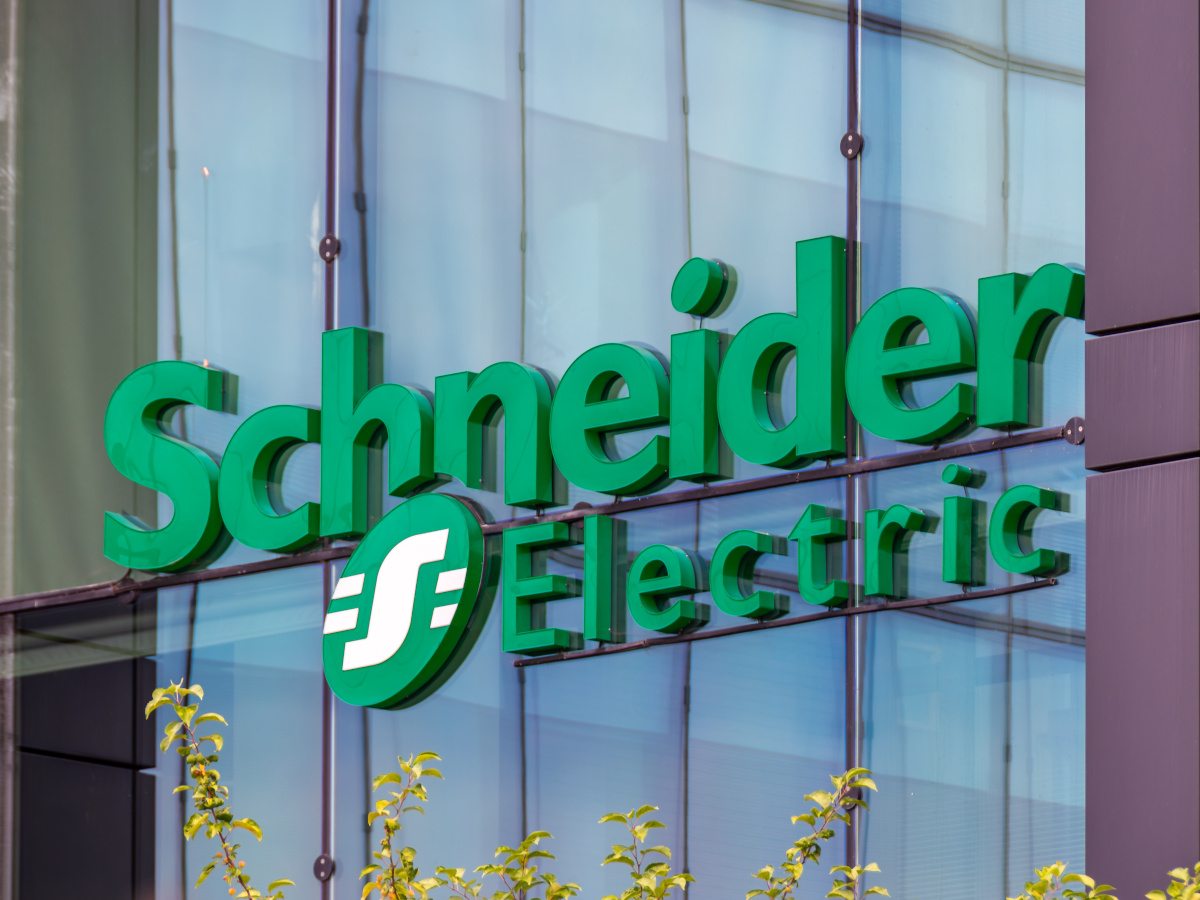 A picture of the green Schneider Electric company name and logo on the side of an office building.