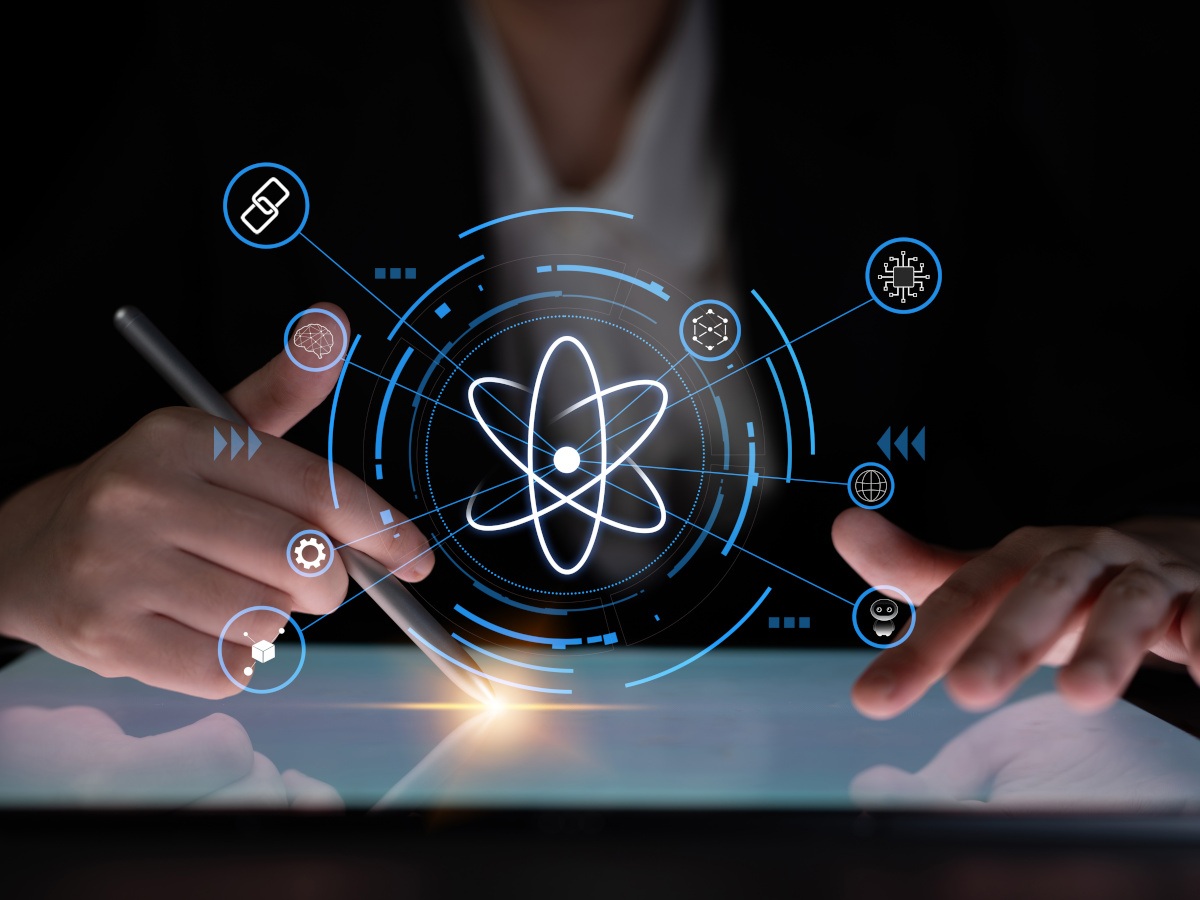 A man on an iPad surrounded by 3D quantum imagery.