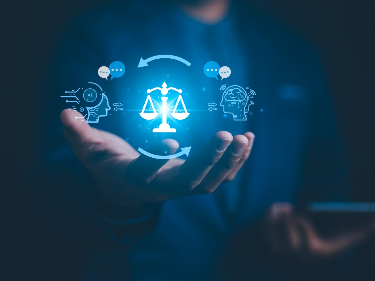 A hand holds a 3D representation if AI and justice icons.