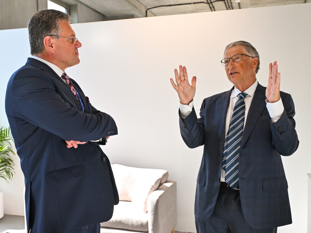 Two men in suits talking to each other.