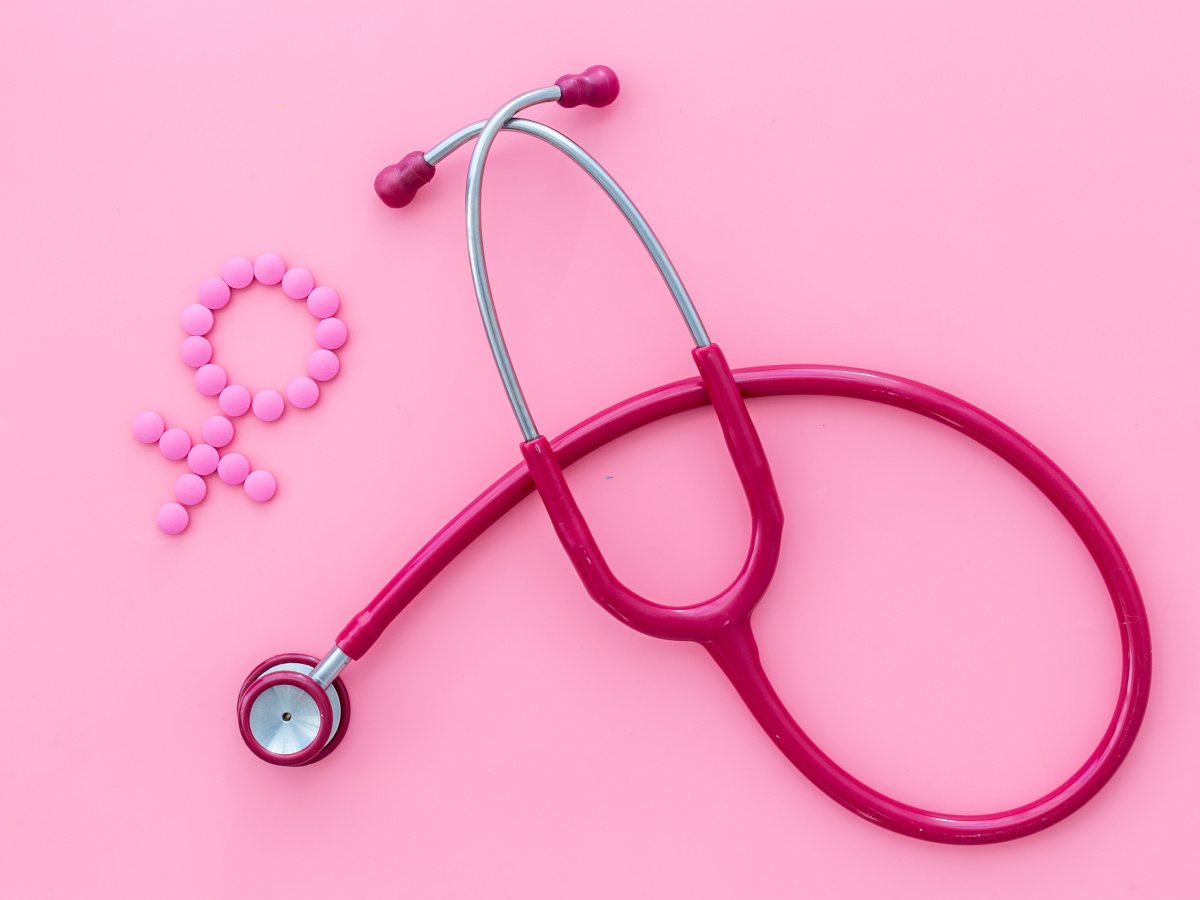A pink stethoscope and gender icon against a pink background.