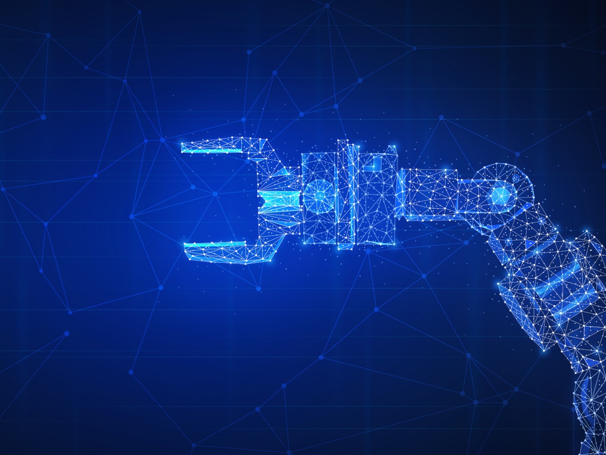 An automated robot claw against a blue background.