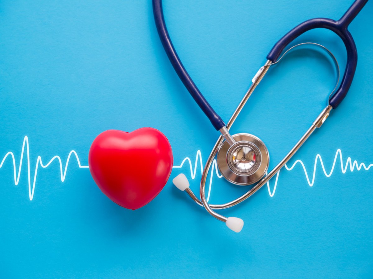 A heart, pulse and stethoscope against a blue background.