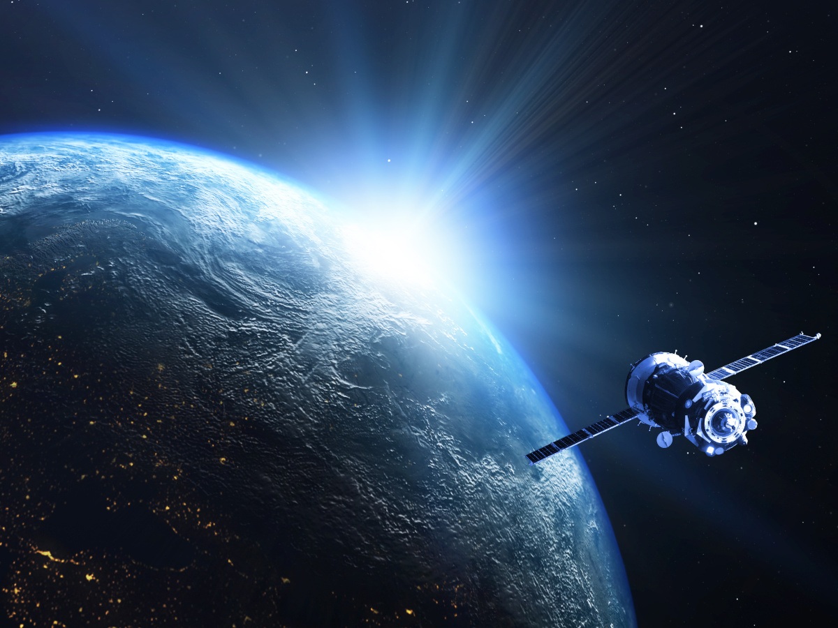 A side view of the Earth as a satellite moves around it.