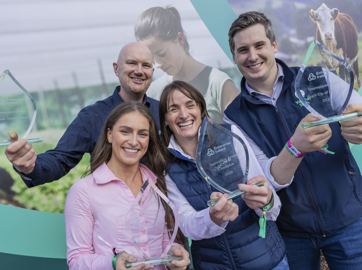 Two women and two men all smiling while holding Enterprise Ireland award trophies.