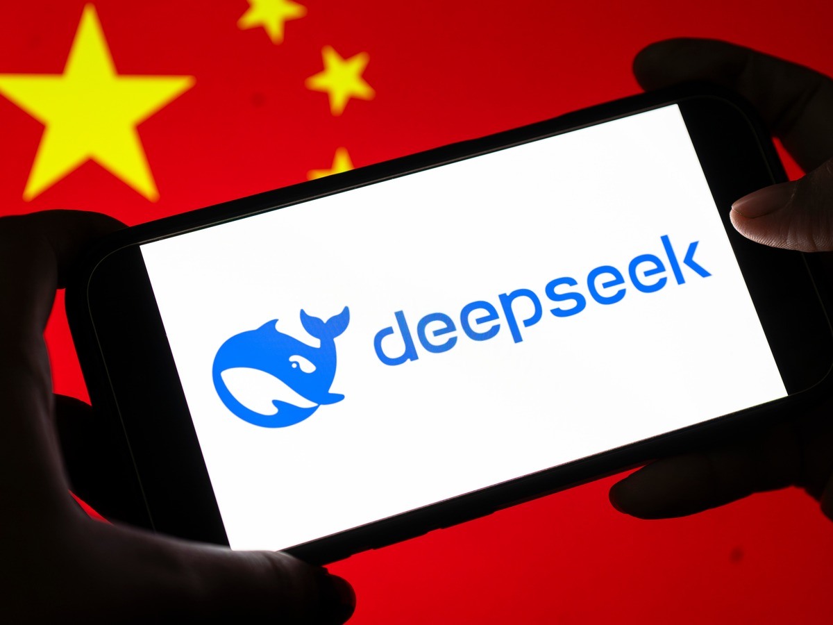 A phone with the DeepSeek logo against a Chinese flag.