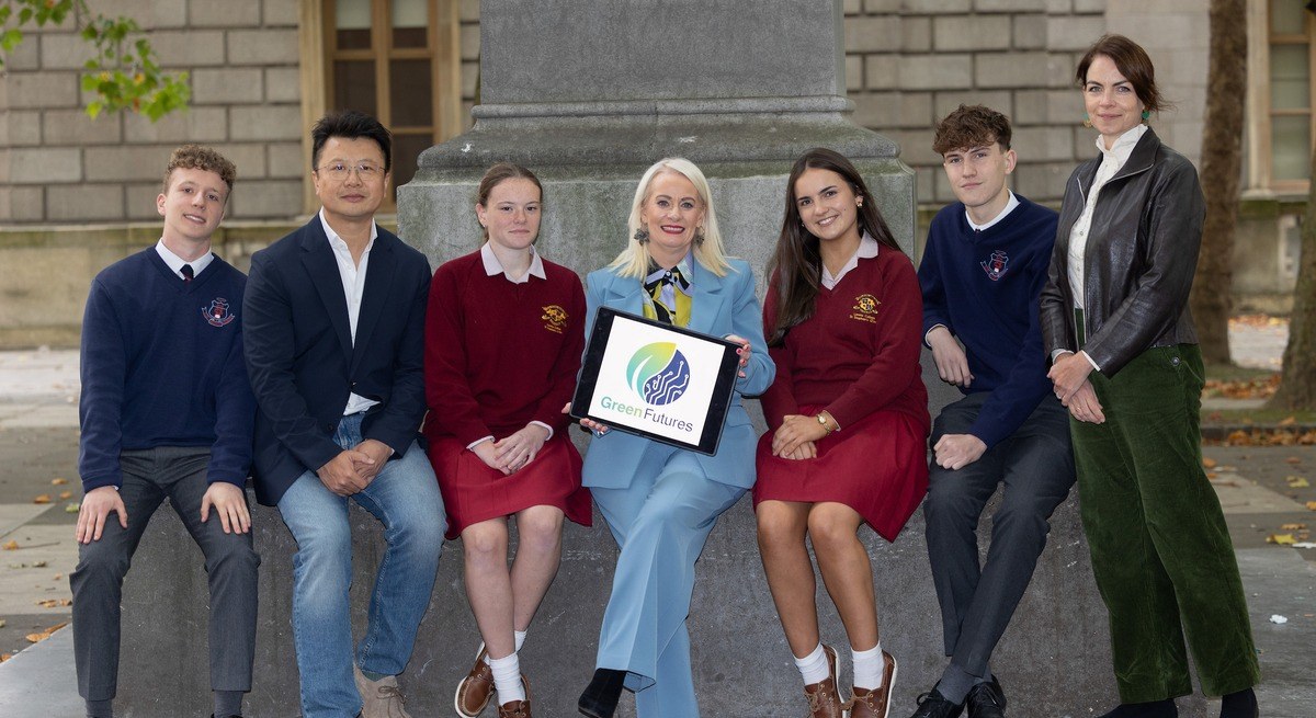 Transition year students in school uniforms with personnel from the government and GreenFutures.