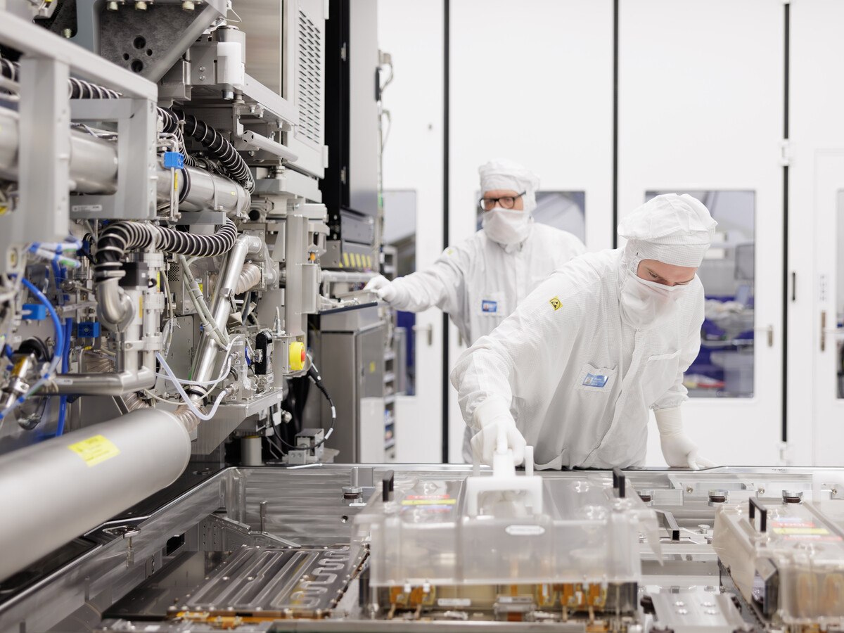 A laboratory with two people in white PPE.