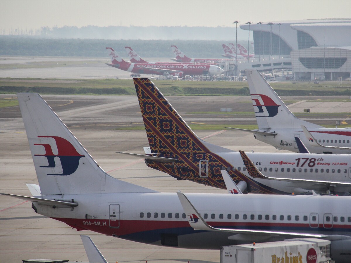 Aircrafts in the Kuala Lampur airport during day.