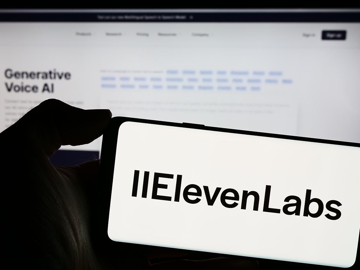 A phone and laptop showing black and white ElevenLabs logo and interface.