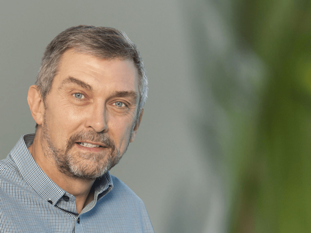 A middle-aged white man smiles for the camera.